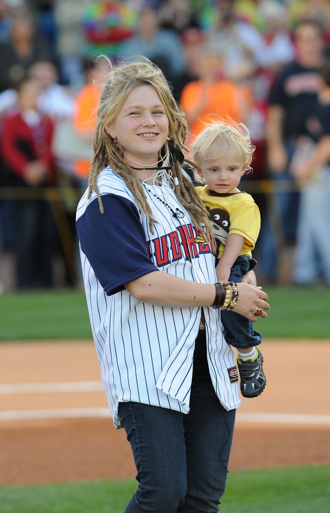 Crystal Bowersox, baseball jersey, jeans, bracelets, dreadlocks